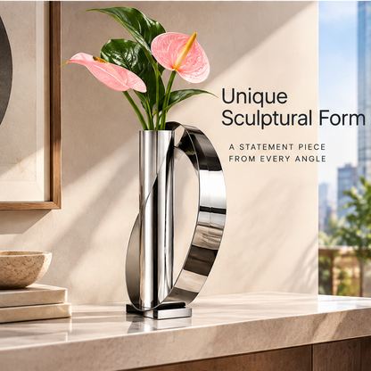 Alternate view of the silver loop vase with pink flowers, showing its sculptural form and rectangular base