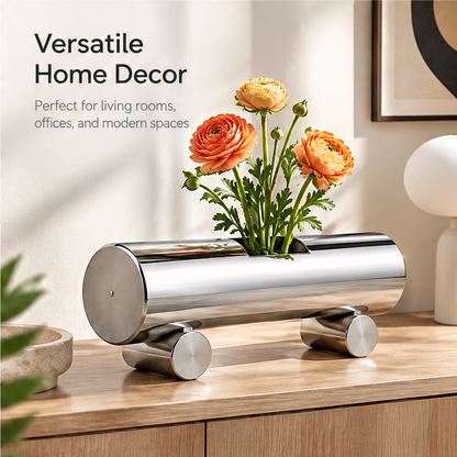 Silver cylindrical vase styled with orange flowers on a wooden console beside versatile home decor text