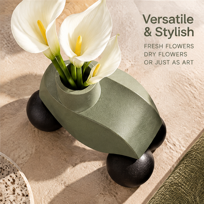 Overhead view of the sage-green sculptural vase with white flowers beside versatile styling text
