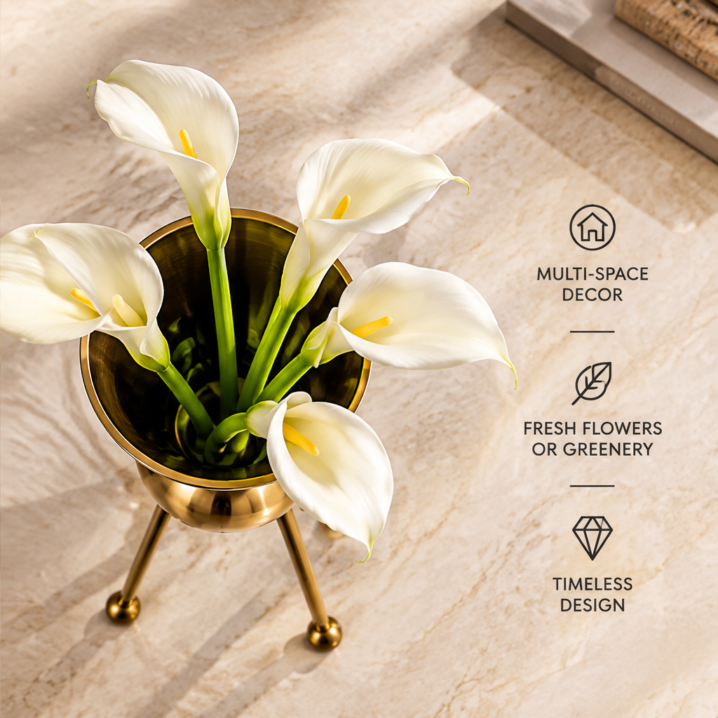 Overhead view of white calla lilies in the gold-tone vase beside flowers and greenery styling text