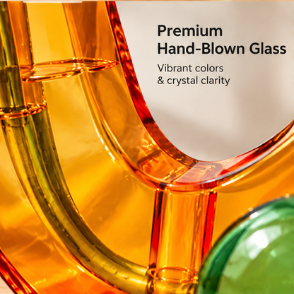 Close-up of the orange glass curve and green accent beside Premium Hand-Blown Glass text